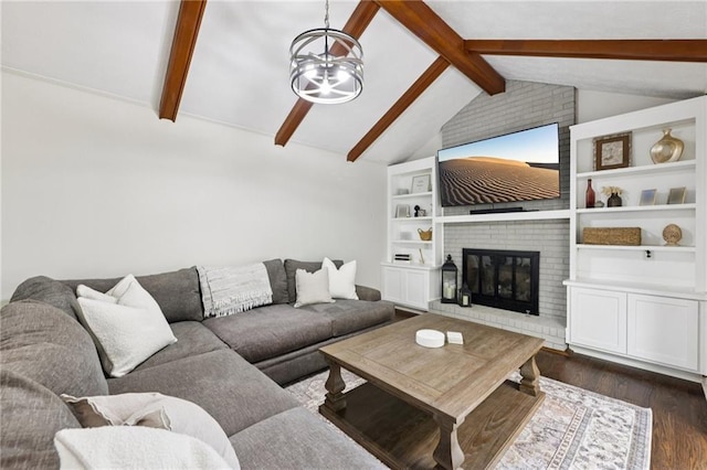 4733 Eidson Rd, Dunwoody, GA 30360 - living room featuring dark wood-style floors, a chandelier, and a fireplace