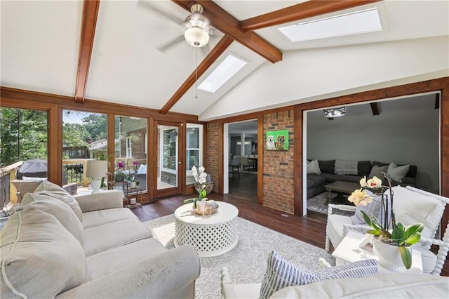 4733 Eidson Rd, Dunwoody, GA 30360 - living room featuring a skylight, plenty of natural light, wood finished floors, and brick wall