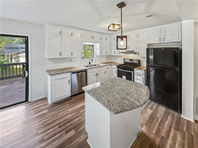 kitchen with sink, white cabinetry, appliances with stainless steel finishes, dark hardwood / wood-style flooring, and pendant lighting