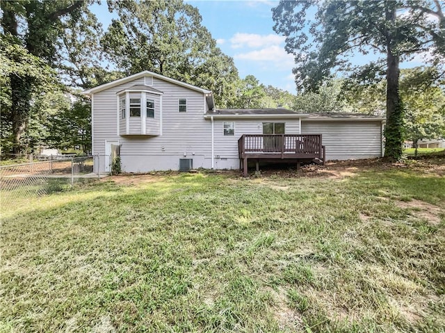 back of property featuring central AC unit, a yard, and a deck