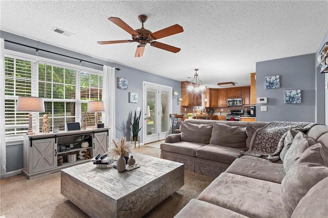 10 Callaway Ct, Hiram, GA 30141 - living area with light carpet, a ceiling fan, a textured ceiling, and a chandelier