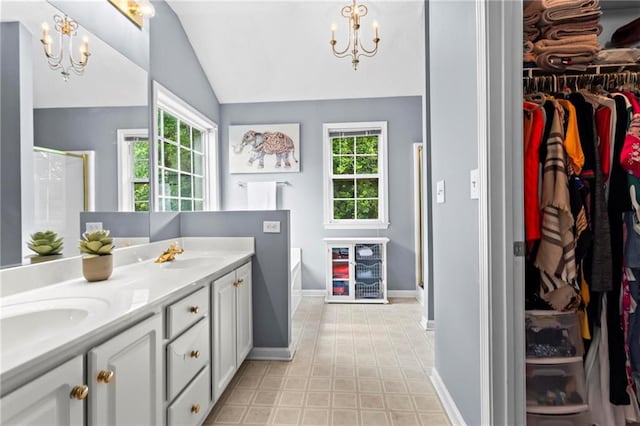 10 Callaway Ct, Hiram, GA 30141 - bathroom with a chandelier, vaulted ceiling, a shower stall, a bathtub, and double vanity