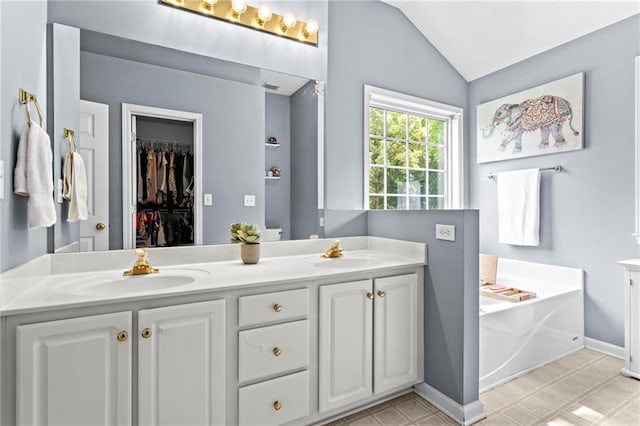 10 Callaway Ct, Hiram, GA 30141 - full bath featuring double vanity, a garden tub, vaulted ceiling, tile patterned floors, and a spacious closet