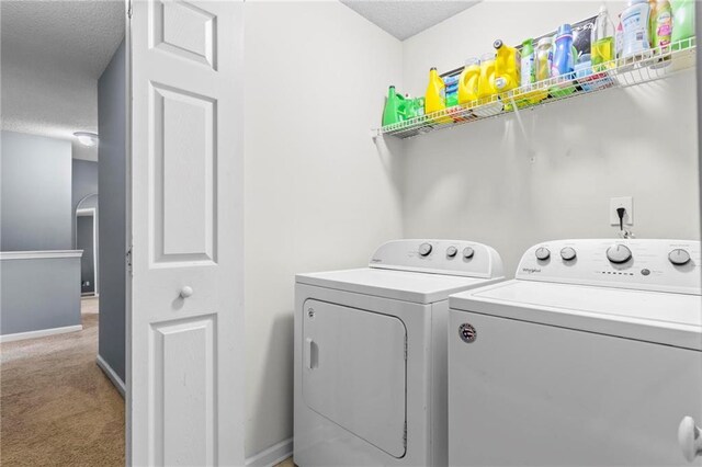 10 Callaway Ct, Hiram, GA 30141 - laundry area featuring washer and clothes dryer, a textured ceiling, and light colored carpet