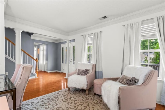 10 Callaway Ct, Hiram, GA 30141 - sitting room with decorative columns, wood finished floors, plenty of natural light, crown molding, and stairs