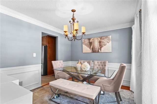 10 Callaway Ct, Hiram, GA 30141 - dining space with a chandelier, ornamental molding, a wainscoted wall, and a textured ceiling
