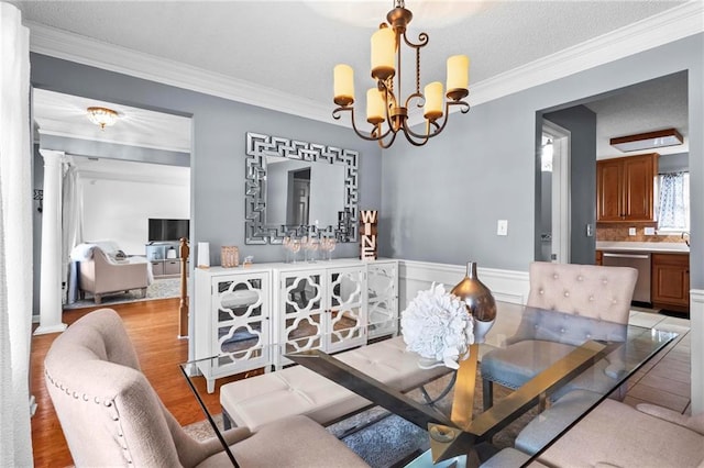 10 Callaway Ct, Hiram, GA 30141 - dining room featuring crown molding, a chandelier, a wainscoted wall, and light wood-style flooring