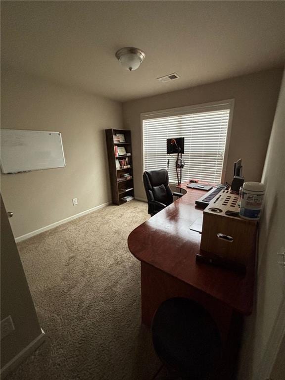 office space with carpet, visible vents, and baseboards