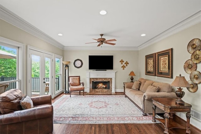 7025 Kettering Ln, Suwanee, GA 30024 - living area featuring dark wood-type flooring, ornamental molding, ceiling fan, a premium fireplace, and recessed lighting