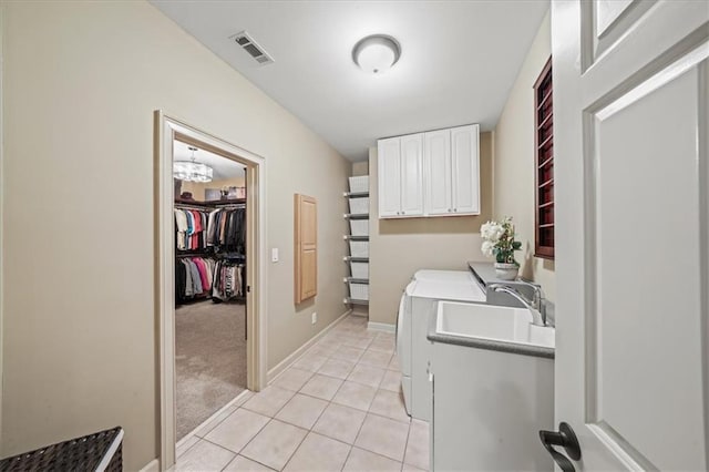 7025 Kettering Ln, Suwanee, GA 30024 - laundry room with independent washer and dryer, cabinet space, light tile patterned flooring, a chandelier, and baseboards