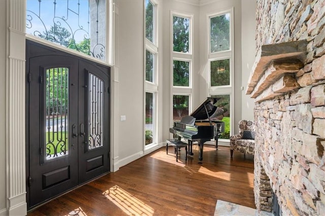 7025 Kettering Ln, Suwanee, GA 30024 - entryway with dark wood-type flooring, a high ceiling, and baseboards