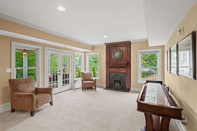 7025 Kettering Ln, Suwanee, GA 30024 - living room featuring french doors, light colored carpet, a fireplace, crown molding, and baseboards