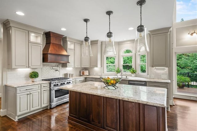 7025 Kettering Ln, Suwanee, GA 30024 - kitchen featuring appliances with stainless steel finishes, custom exhaust hood, healthy amount of natural light, decorative backsplash, and recessed lighting