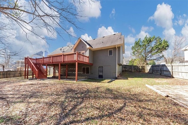 back of house with a deck, a lawn, a fenced backyard, and stairs