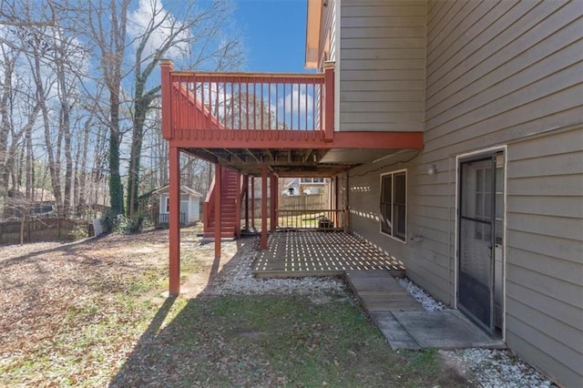 exterior space with fence, stairway, and a wooden deck