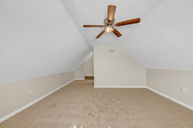 bonus room featuring carpet, baseboards, vaulted ceiling, and a ceiling fan