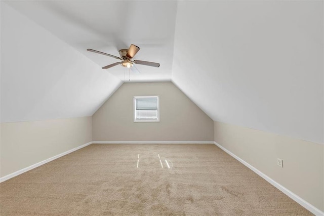 bonus room featuring carpet, baseboards, vaulted ceiling, and a ceiling fan