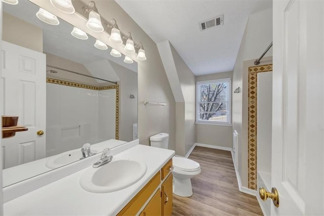 full bathroom featuring visible vents, toilet, vanity, wood finished floors, and a shower with curtain