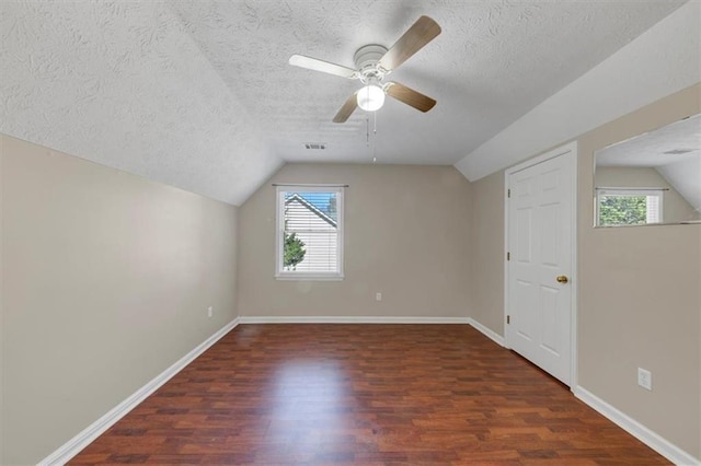 additional living space featuring vaulted ceiling, baseboards, and wood finished floors