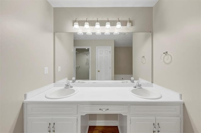 full bathroom featuring a sink and double vanity