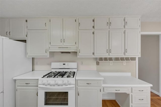 kitchen with light countertops, white appliances, white cabinets, and under cabinet range hood