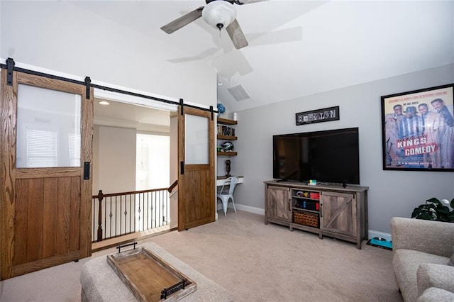 carpeted living room with a barn door, lofted ceiling, and ceiling fan