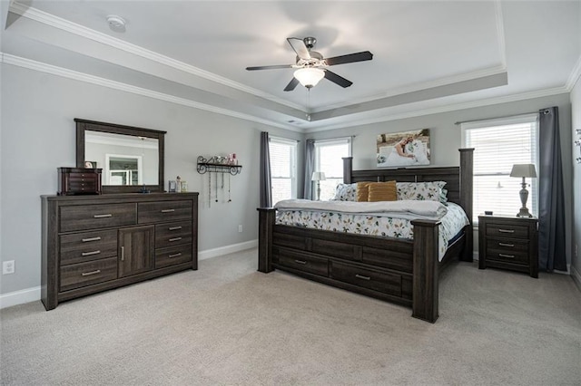 carpeted bedroom featuring a raised ceiling, crown molding, and ceiling fan