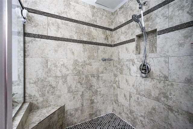 bathroom with a tile shower