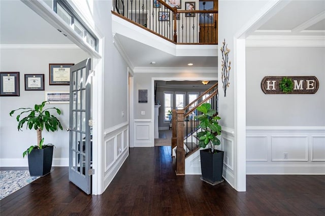 entryway with ornamental molding, dark hardwood / wood-style flooring, and french doors