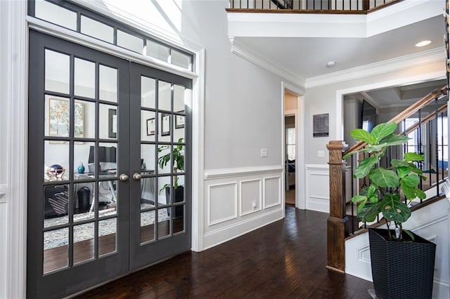 doorway with french doors, dark hardwood / wood-style floors, plenty of natural light, and crown molding