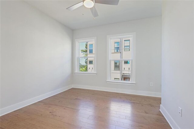 1030 Burnside Pl NW, Atlanta, GA 30318 - empty room with light wood finished floors, ceiling fan, and baseboards