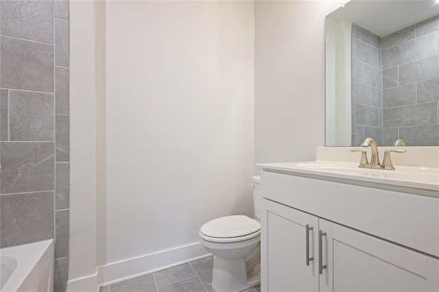 1030 Burnside Pl NW, Atlanta, GA 30318 - bathroom featuring toilet, baseboards, vanity, a bath, and marble finish flooring