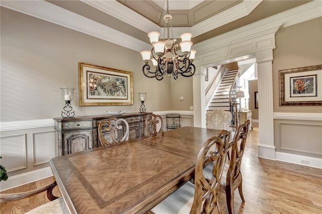 8340 Royal Melbourne Way, Duluth, GA 30097 - dining area featuring a decorative wall, a chandelier, stairs, crown molding, and light wood finished floors