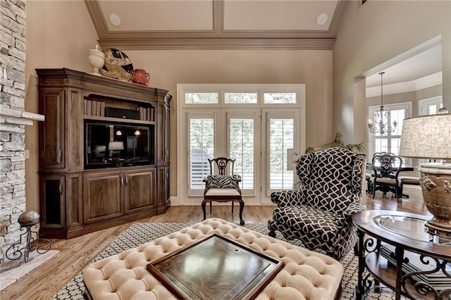 8340 Royal Melbourne Way, Duluth, GA 30097 - living room with ornamental molding, plenty of natural light, light wood-style flooring, and a chandelier