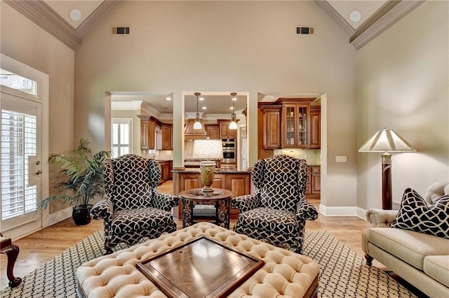 8340 Royal Melbourne Way, Duluth, GA 30097 - living room featuring ornamental molding, high vaulted ceiling, light wood-type flooring, and baseboards