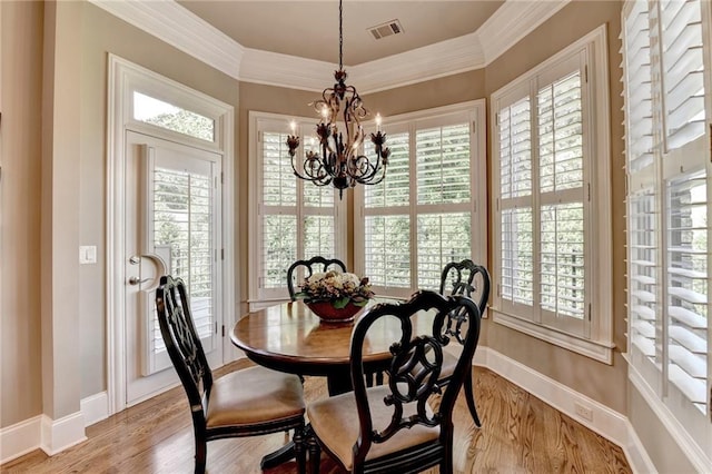 8340 Royal Melbourne Way, Duluth, GA 30097 - dining area with a chandelier, plenty of natural light, baseboards, light wood finished floors, and crown molding