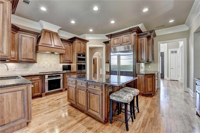 8340 Royal Melbourne Way, Duluth, GA 30097 - kitchen featuring stainless steel appliances, custom exhaust hood, a kitchen island, crown molding, and a sink