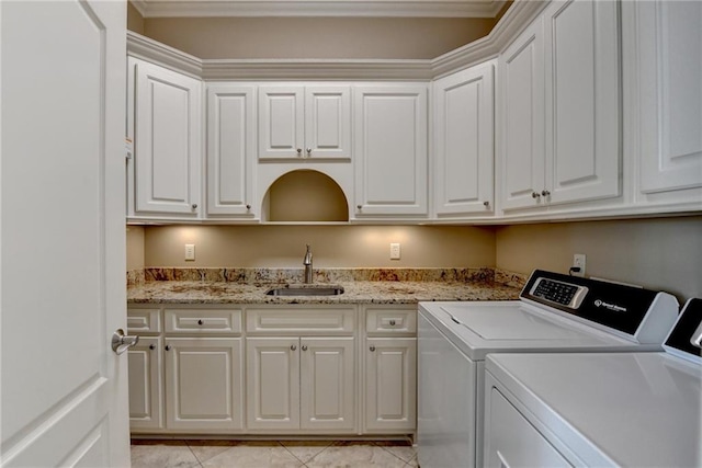 8340 Royal Melbourne Way, Duluth, GA 30097 - washroom featuring washing machine and clothes dryer, cabinet space, light tile patterned flooring, and ornamental molding