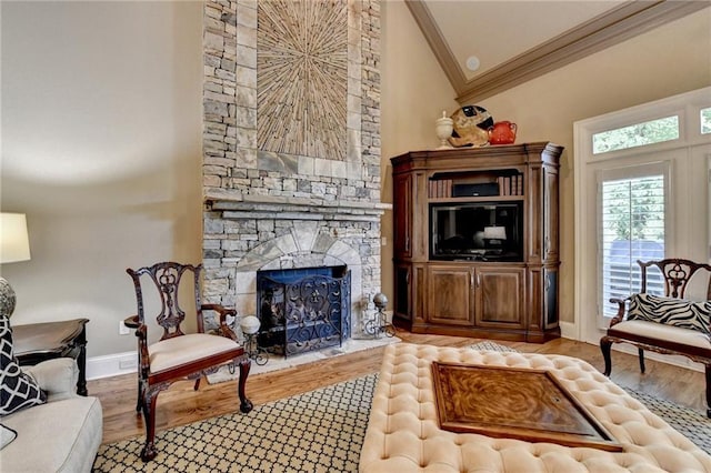 8340 Royal Melbourne Way, Duluth, GA 30097 - living room with ornamental molding, lofted ceiling, baseboards, wood finished floors, and a stone fireplace