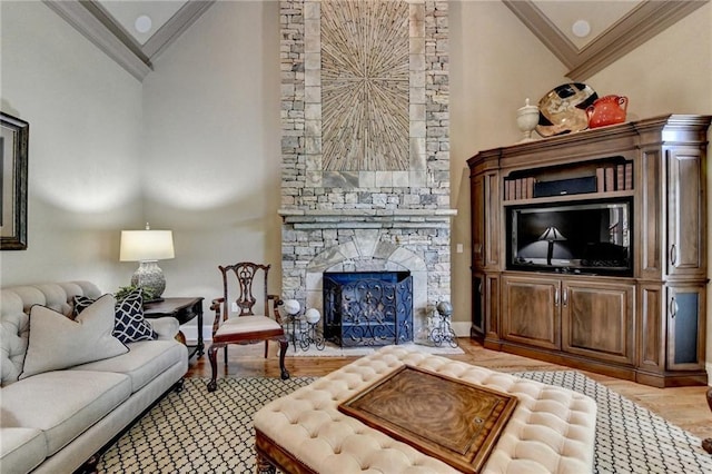 8340 Royal Melbourne Way, Duluth, GA 30097 - living area featuring crown molding, wood finished floors, and a stone fireplace