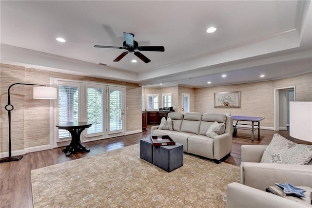 8340 Royal Melbourne Way, Duluth, GA 30097 - living room with a tray ceiling, a ceiling fan, baseboards, recessed lighting, and wood finished floors