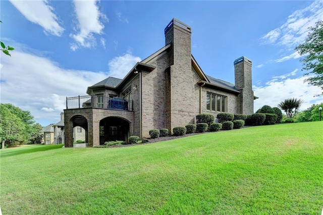 8340 Royal Melbourne Way, Duluth, GA 30097 - view of side of property with a balcony, a chimney, a yard, and brick siding