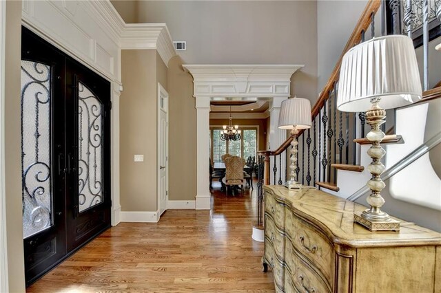 8340 Royal Melbourne Way, Duluth, GA 30097 - entryway with a chandelier, stairs, light wood-style flooring, french doors, and baseboards