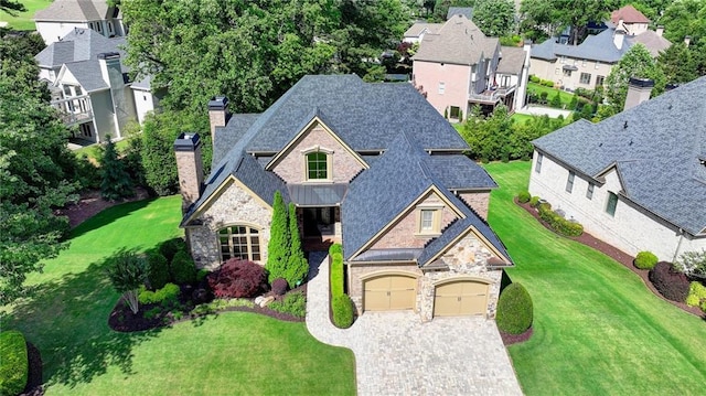 8340 Royal Melbourne Way, Duluth, GA 30097 - view of front of home featuring stone siding, a chimney, decorative driveway, and roof with shingles
