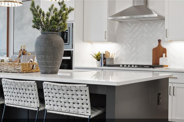 9110 Greenway Ct, Gainesville, GA 30506 - kitchen with wall chimney range hood, white cabinetry, tasteful backsplash, and appliances with stainless steel finishes