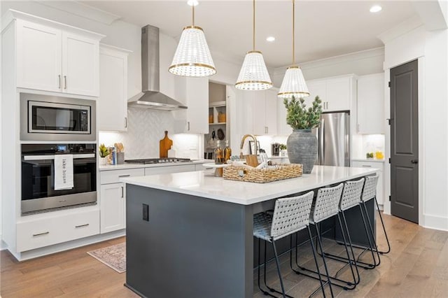 9110 Greenway Ct, Gainesville, GA 30506 - kitchen featuring stainless steel appliances, wall chimney range hood, white cabinetry, recessed lighting, and light countertops