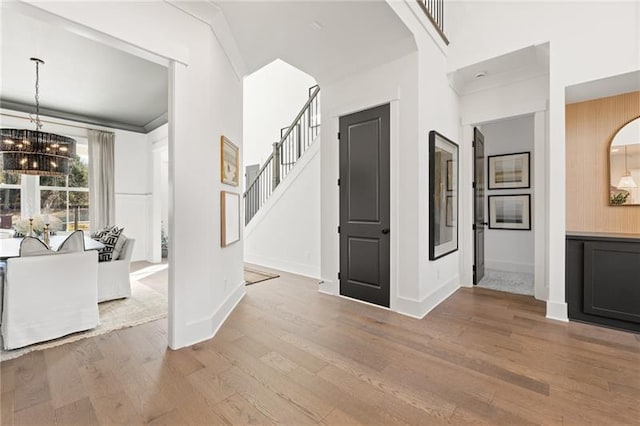 9110 Greenway Ct, Gainesville, GA 30506 - foyer featuring a chandelier, wood finished floors, stairway, and baseboards