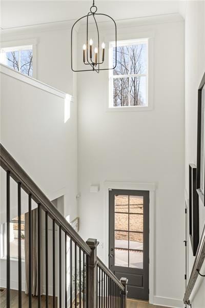 9110 Greenway Ct, Gainesville, GA 30506 - foyer entrance featuring a chandelier, a high ceiling, stairs, and wood finished floors