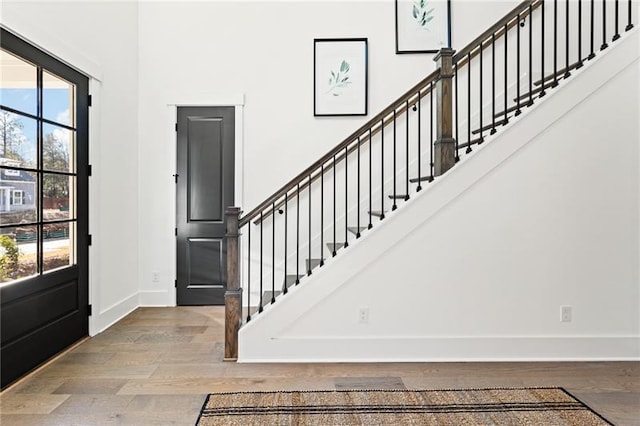 9110 Greenway Ct, Gainesville, GA 30506 - entrance foyer featuring baseboards, wood finished floors, stairway, and a high ceiling