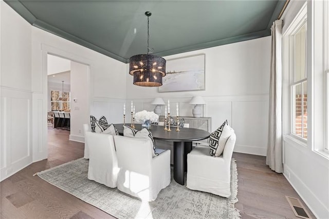 9110 Greenway Ct, Gainesville, GA 30506 - dining area with a decorative wall, a chandelier, wood finished floors, and wainscoting